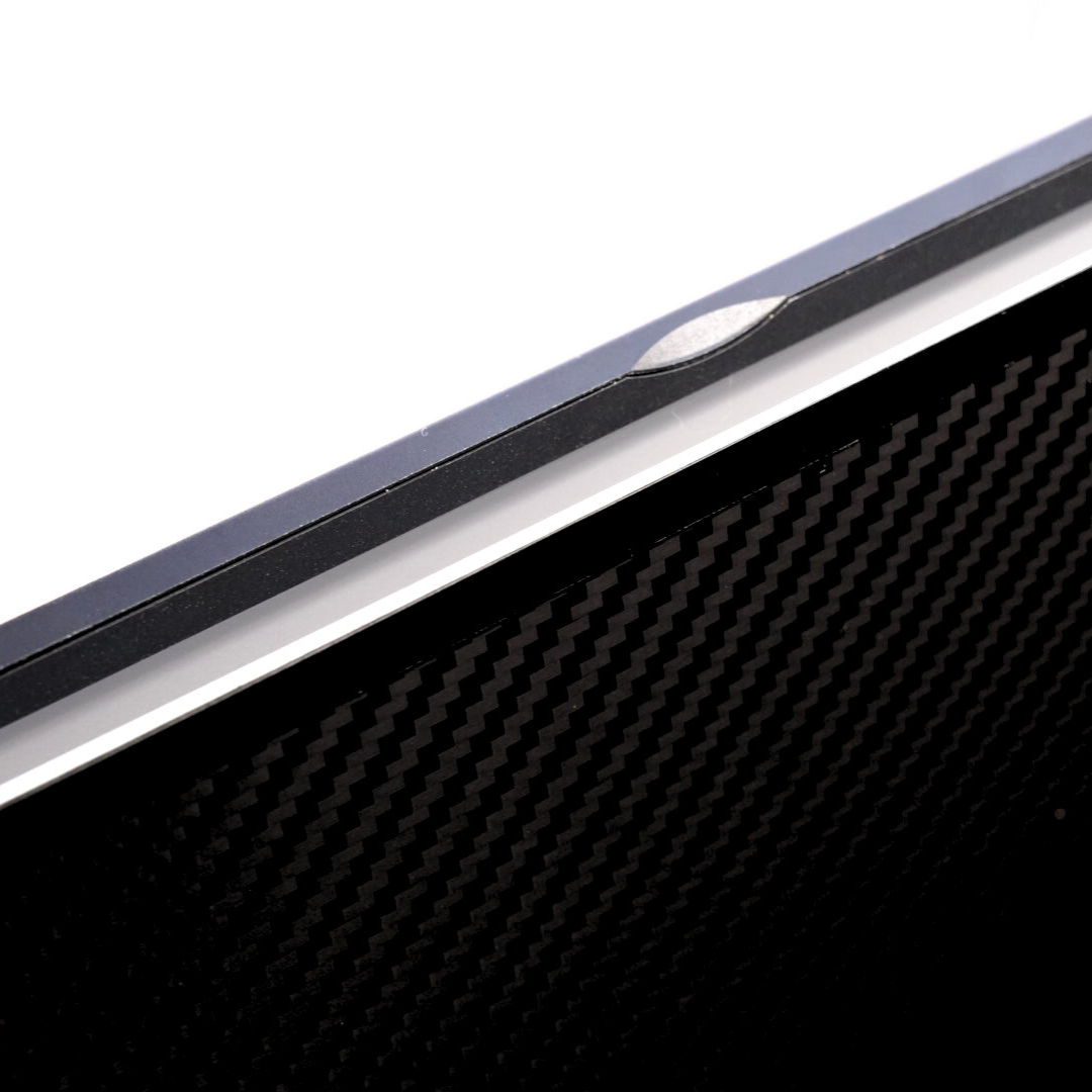 Close-up of Eazeye Monitor 1 back panel showing carbon-fiber texture and open lid