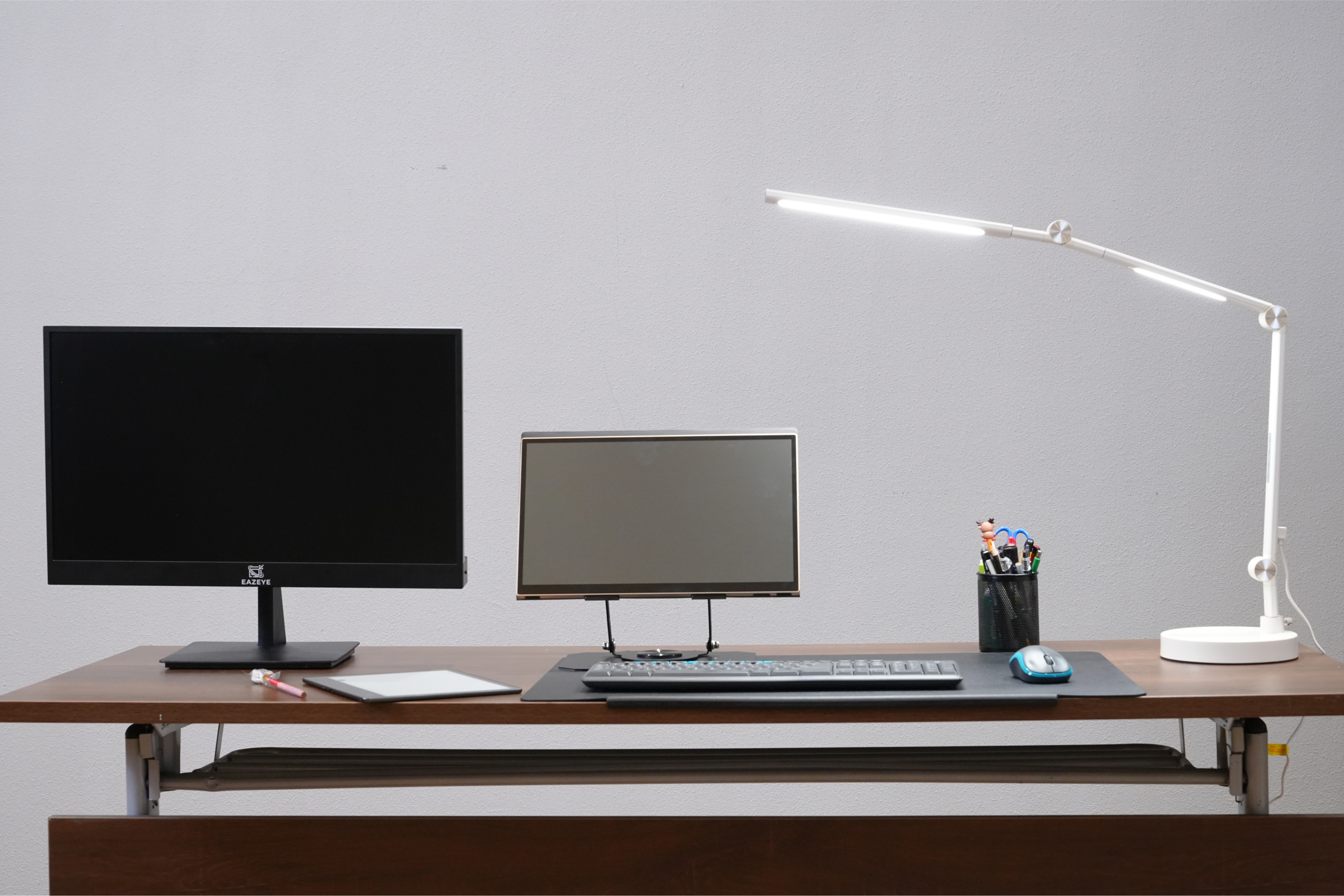 Desk setup with Eazeye Monitor 1, Radiant monitor, and Eazeye Lumen LED lamp