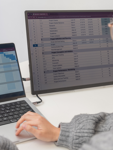 Woman using Eazeye Monitor 2.0 indoors, working on a spreadsheet with its paper-like display and anti-glare properties for optimal comfort.