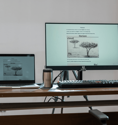 Eazeye Monitor 1 on desk mirroring laptop screen, reflective ambient-lit display