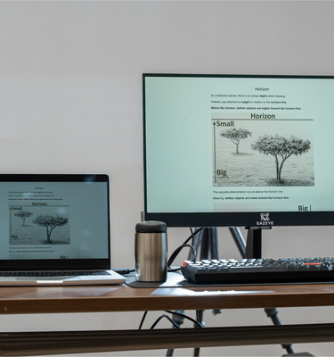 Eazeye Monitor 1 with ink-style tree image, mirroring laptop on desk with thermos and keyboard