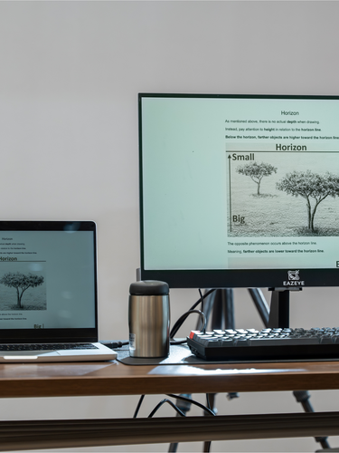 Eazeye Monitor 1 with ink-style tree image, mirroring laptop on desk with thermos and keyboard
