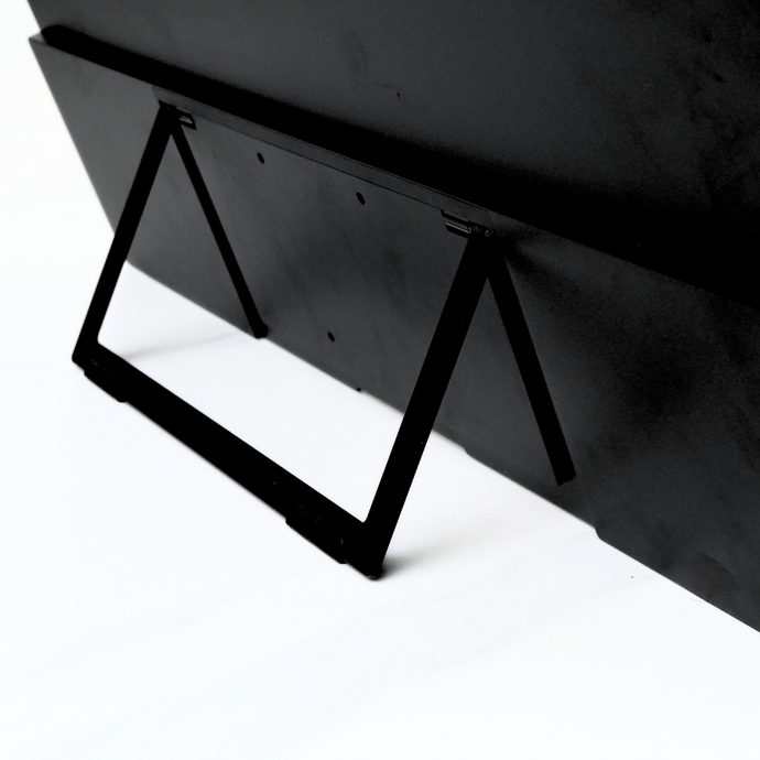Back 3/4 close-up of Eazeye Monitor 2 built-in kickstand resting on white surface