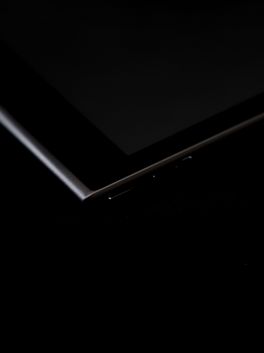 Teaser close-up of Paper 2 on dark background, reflective RLCD device