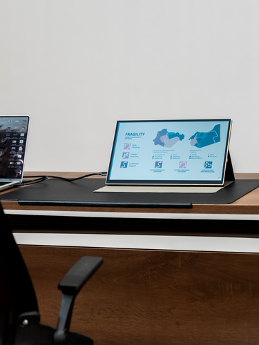 Radiant monitor on desk connected to laptop, mirroring screen with transflective LCD