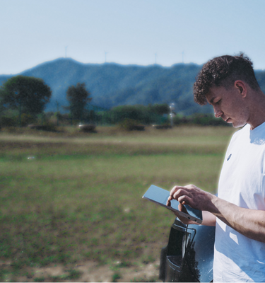 Man using Eazeye Radiant Monitor outdoors, highlighting its bright, glare-free display and portable design for easy viewing anywhere.