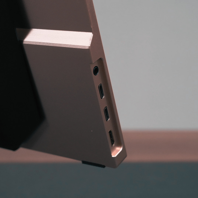 Close-up of Radiant monitor ports: 2 USB-C, 1 HDMI, 1 AUX — connectivity details