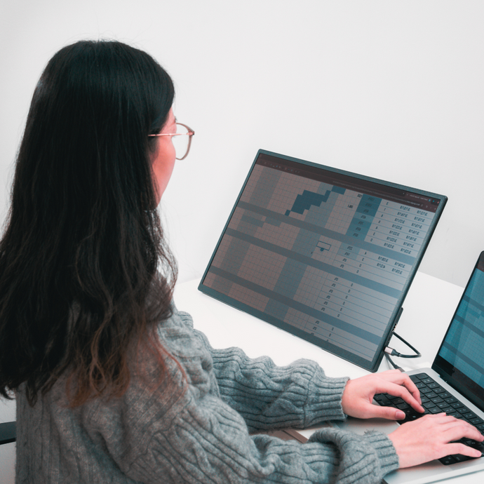 Woman using Eazeye Monitor 2 mirrored to her laptop for seamless dual-screen work