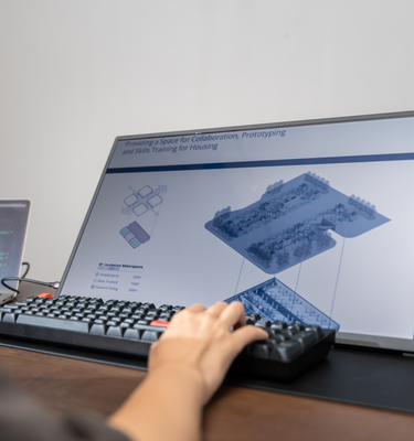 Woman working with Eazeye Monitor 2 in an office, reflective RLCD workspace display