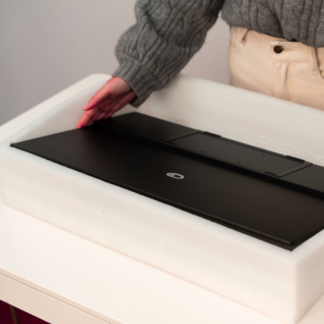 Woman unboxing Eazeye Monitor 2 indoors, first look at RLCD display