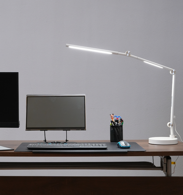 Radiant monitor, Eazeye Monitor 1 and Eazeye Lumen LED lamp on desk — ergonomic workspace setup